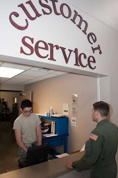 Airman 1st Class Shawn Roberts, 436th Operations Support Squadron aircrew flight equipment technician, helps a customer June 9, 2014, at Dover Air Force Base, Del.  AFE customer service is open 24 hours to ensure aircrews get the equipment they need. (U.S. Air Force photo/Senior Airman Jared Duhon)