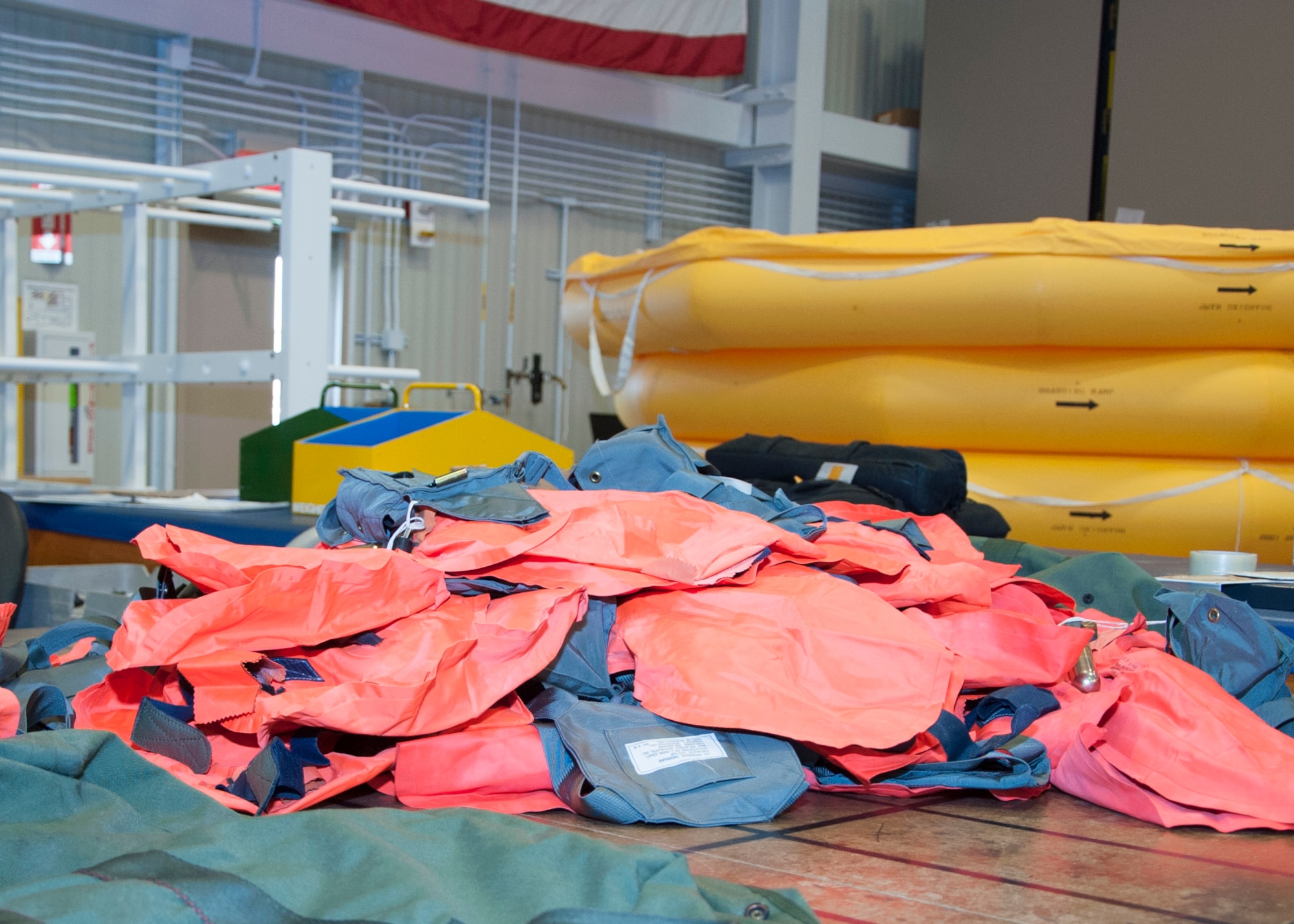Life vests sit on a table to be inspected June, 9, 2014, at Dover Air Force Base, Del. The 436th Operations Support Squadron aircrew flight equipment team ensures safety equipment is ready to be used in case of emergencies. (U.S. Air Force photo/Senior Airman Jared Duhon)