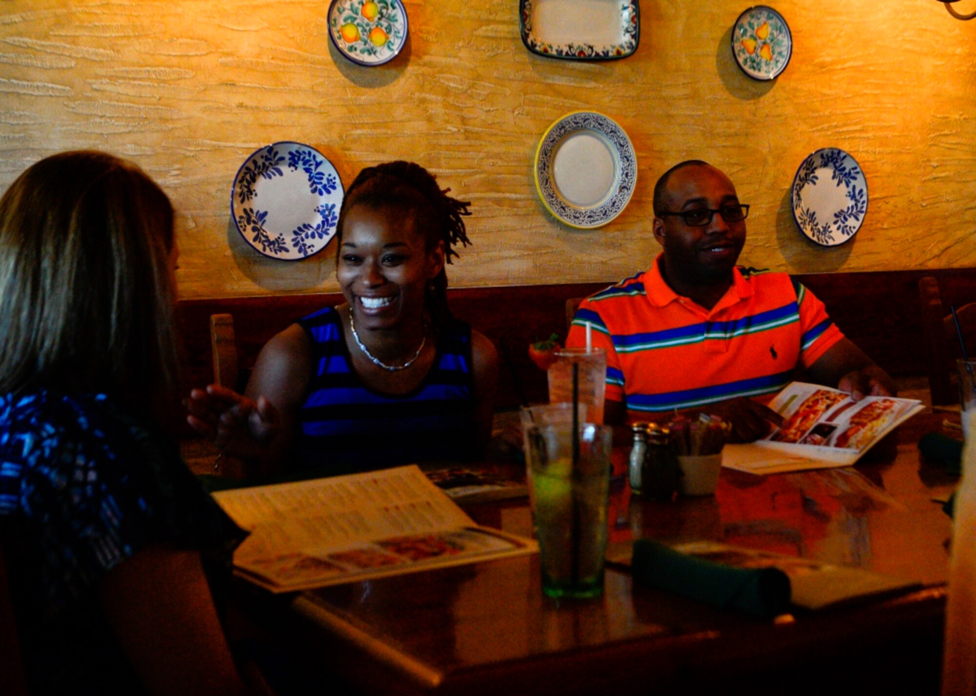 Shamika Chamberlain, wife of deployed Staff Sgt. Lavondre Chamberlain, speaks to Staff Sgt. Lori Campbell, 436th Logistics Readiness Squadron vehicle operations dispatcher, at a single  parents appreciation dinner June 6, 2014, at Olive Garden in Dover, Del. Chamberlain is a married spouse, but was invited because her husband is deployed and she has assumed the responsibilities as a single parent. (U.S. Air Force photo/Airman 1st Class William Johnson)