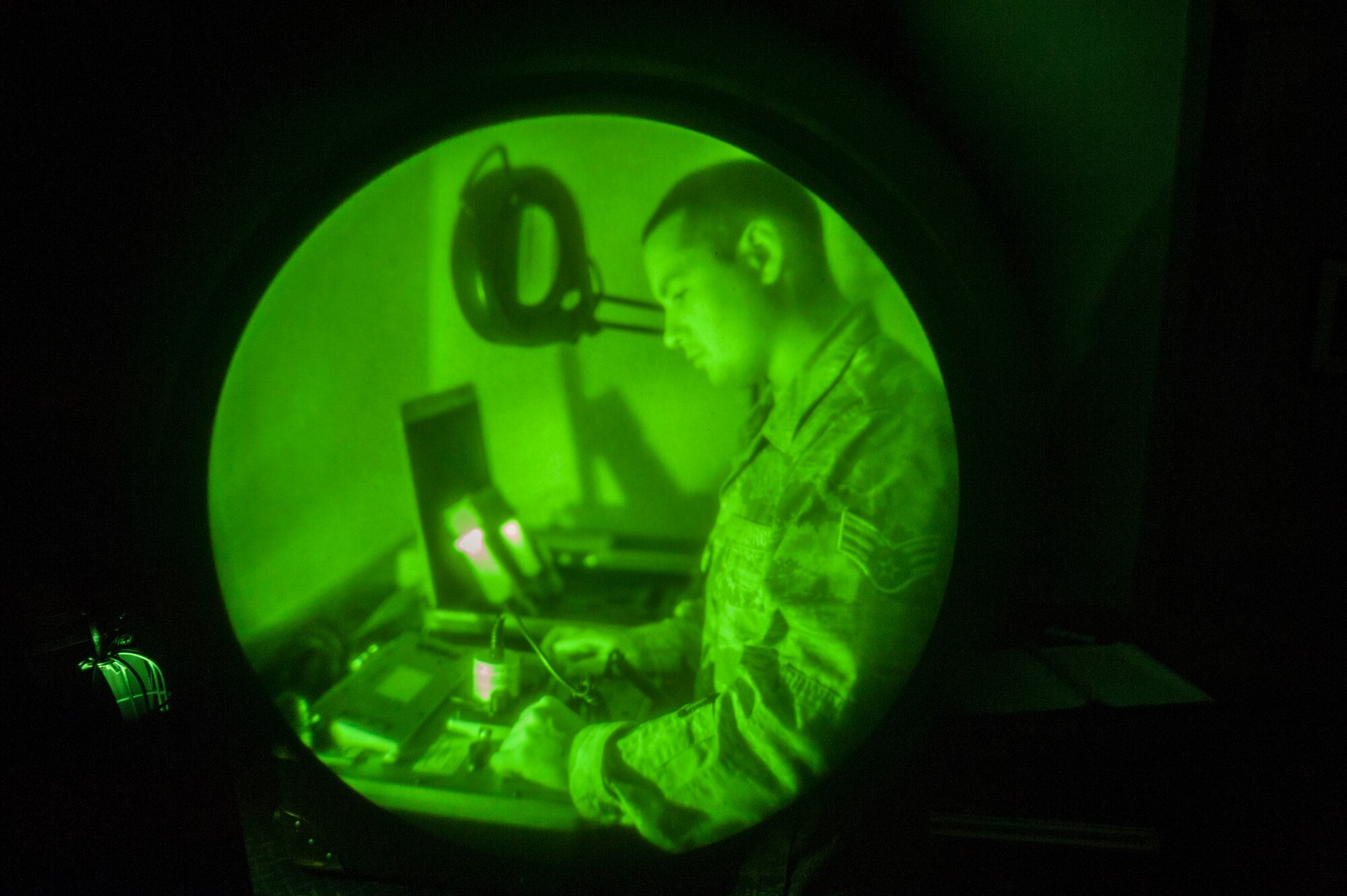 Senior Airman Elias Gallardo-Baez, 436th Operations Support Squadron aircrew flight equipment technician, inspects night vision goggles June 9, 2014, at Dover Air Force Base, Del.  The goggles provide operators improved situational awareness during periods of low natural illumination by amplifying light from the moon and stars. (U.S. Air Force photo/Senior Airman Jared Duhon)