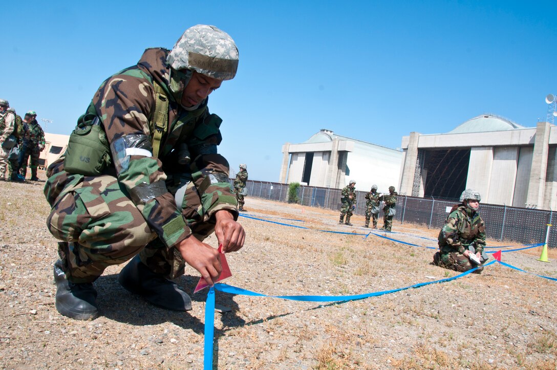 California Air National Guardsmen from the 129th Rescue Wing participate in War Skills Training at Moffett Federal Airfield, Calif., June 7, 2014.  The hands-on training provides airmen the opportunity to react to various Air Expeditionary Force and emergent mission tasking scenarios, including cover and concealment, and self-aid and buddy care. (U.S. Air National Guard photo by Senior Airman Rachael Kane/Released)