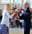 Tammy Denehan receives flowers during a change of command ceremony at Minot Air Force Base, N.D., June 6, 2014. Her husband Col. Kieran Denehan took over as the 5th Operations Group commander. (U.S. Air Force photo/Senior Airman Andrew Crawford)