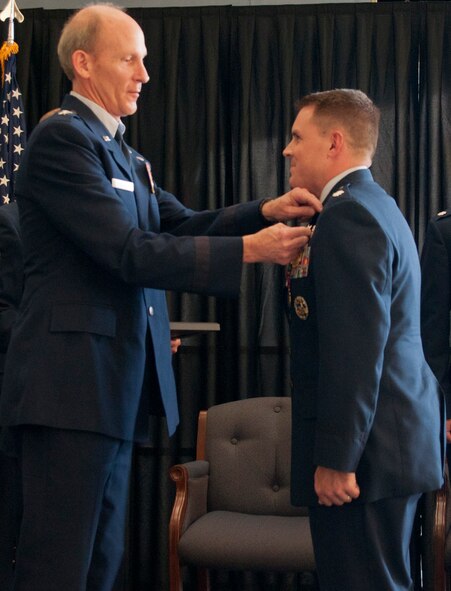 U.S. Air Force Brig.Gen. William N. Reddel, III, Adjutant General of New Hampshire, awards the N.H. National Guard Distinguished Service medal to U.S. Air Force Lt. Col. J. Scot Heathman, Commander, 64th Air Refueling Squadron, Pease Air National Guard Base, N.H., during a change of command ceremony held at Pease, June 8, 2014.  Heathman relenquished command to U.S. Air Force Lt. Col. Bradley Stevens during the ceremony.