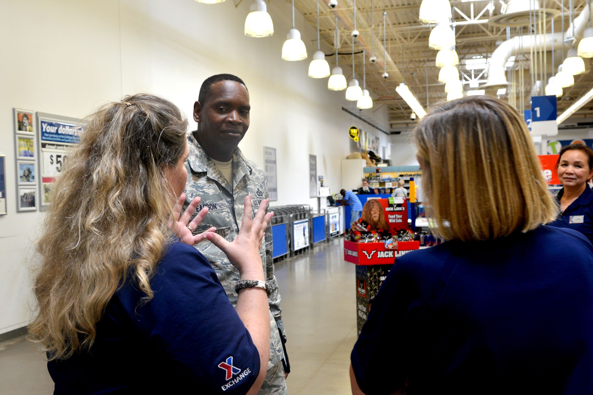 U.S. Air Force Chief Master Sgt. Tony Pearson, Army & Air Force Exchange Service senior enlisted advisor, is briefed on how The Exchange has been running at Shaw Air Force Base, S.C., June 4, 2014. During the tour he met with Airmen and community members and talked about how the Exchange can better serve them, including updating its assortment of name-brand merchandise in store and online. (U.S. Air Force photo by Senior Airman Ashley Gardner/Released)