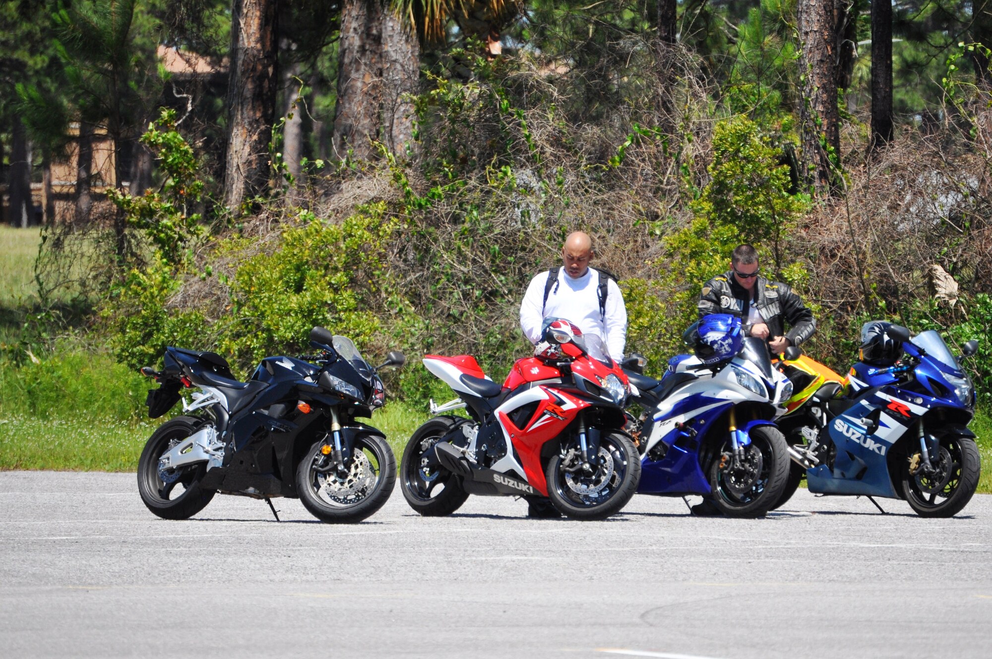Several motorcycles and Airmen stand ready to be used June 9 as part of the motorcycle mentorship event. The vent correlated with the quarterly Comprehensive Airman Fitness Day which focused on Sexual Assault Prevention Response (U.S Air Force photo by 2nd Lieutenant Christopher Bowyer-Meeder)