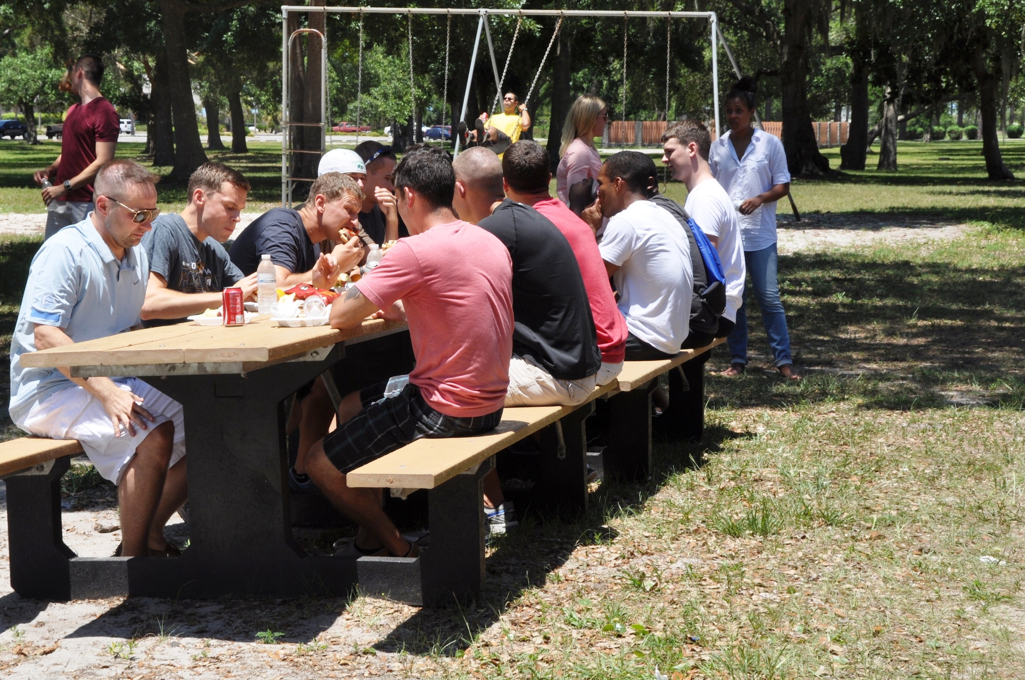 Members of Team Tyndall enjoy a complimentary burger burn June 9 at Heritage Park during the quarterly Comprehensive Airman Fitness Day. This CAF Day was focused on Sexual Assault Prevention Response. (U.S. Air Force photo by Staff Sgt. Rachelle Blake)