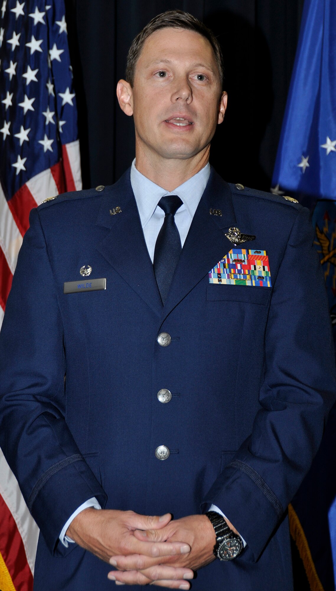 Lt. Col. Fritz Wilde addresses the crowd June 7, 2014 at Peterson Air Force Base, Colo. after assuming command of the Air Force Reserve Command’s 302nd Operations Support Squadron. Wilde is a master navigator with more than 3,500 hours in the C-130 E, H, and H3 models. (U.S. Air Force photo/Master Sgt. Daniel Butterfield) 