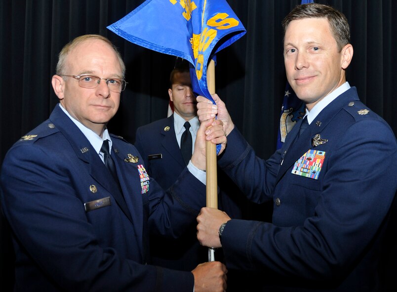 Lt. Col. Fritz Wilde, right, accepts the 302nd Operations Support Squadron guideon from Col. Kurt Jones, 302nd Operations Group commander during a change of command ceremony held June 7, 2014 at Peterson Air Force Base, Colo. Wilde assumed command from Lt. Col. Christopher Lay, who is attending U.S. Army War College. (U.S. Air Force photo/Master Sgt. Daniel Butterfield)