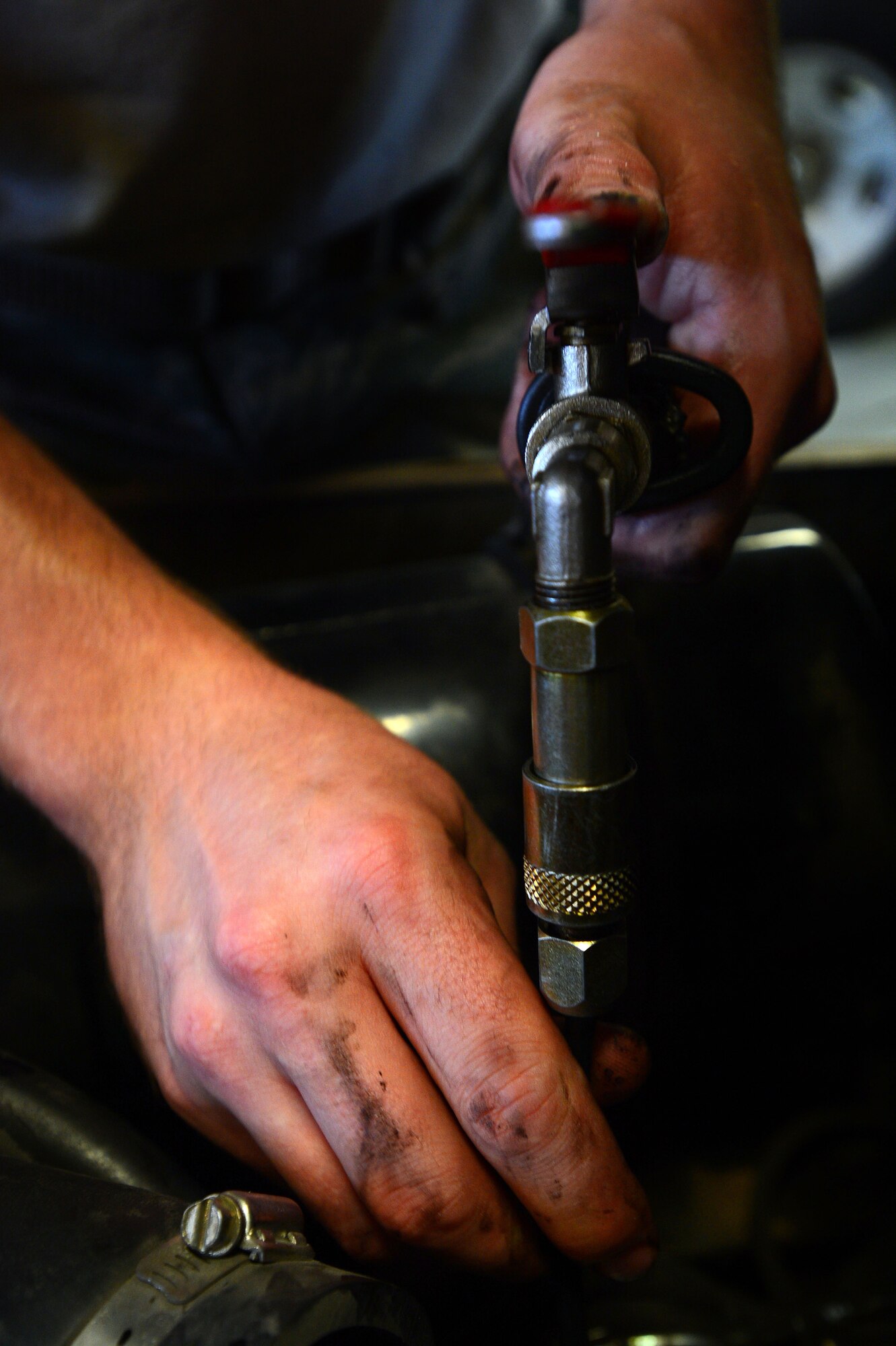 A 20th Logistics Readiness Squadron vehicle maintenance Airman, adds new oil to a forklift after a routine oil change at Shaw Air Force Base, S.C., June 04, 2014. The vehicle maintenance shop performs maintenance on approximately 109 vehicles each month to ensure the safety and mission readiness of Airmen across the 20th Fighter Wing. (U.S. Air Force photo by Airman 1st Class Jensen Stidham/Released)