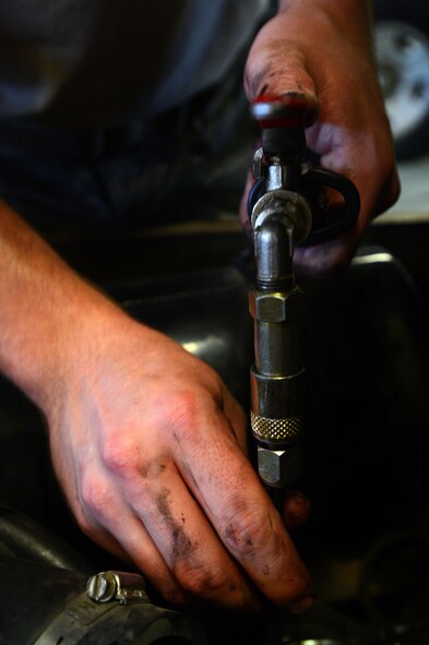 A 20th Logistics Readiness Squadron vehicle maintenance Airman, adds new oil to a forklift after a routine oil change at Shaw Air Force Base, S.C., June 04, 2014. The vehicle maintenance shop performs maintenance on approximately 109 vehicles each month to ensure the safety and mission readiness of Airmen across the 20th Fighter Wing. (U.S. Air Force photo by Airman 1st Class Jensen Stidham/Released)