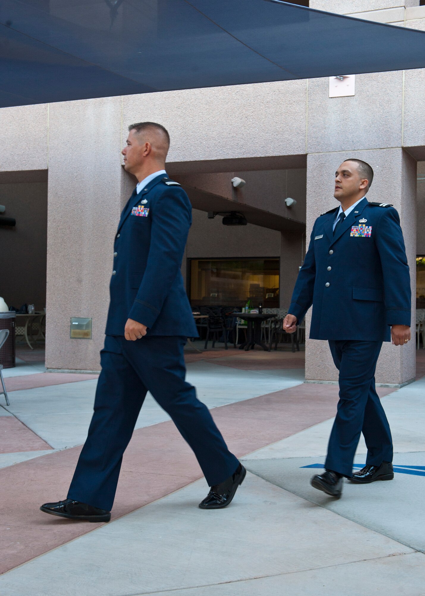 U.S Air Force 1st Lt. Kevin Stuessy (left), and 1st Lt. Christopher Gomez, Interservice Physician Assistant Program students, enter at the beginning of their graduation ceremony at the Mike O’Callaghan Federal Medical Center, June 6, 2014, at Nellis Air Force Base, Nev. Graduates of the IPAP are commissioned as First Lieutenants, if they are not already officers, and receive a Master Physician Assistant Studies diploma from the program’s affiliate, the University of Nebraska Medicine Center. (U.S. Air Force photo by Airman 1st Class Thomas Spangler)