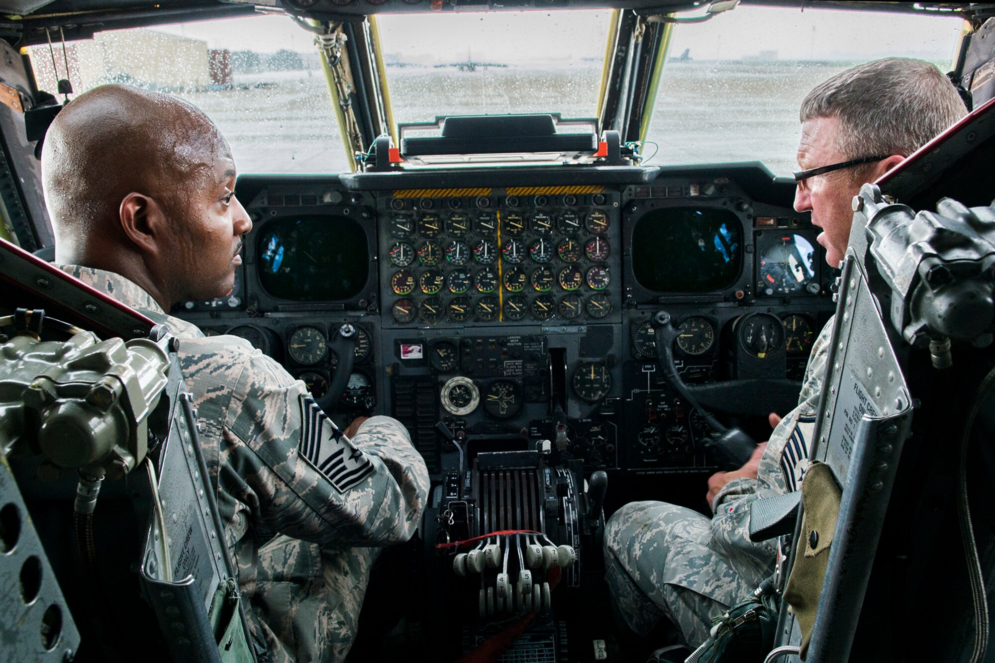 U.S. Air Force Reserve Command Chief Master Sgt. Cameron Kirksey (left) experiences just how hot the cockpit of a B-52H Stratofortress can get during a tour of the 307th Bomb Wing on June 8, 2014, Barksdale Air Force Base, La. This is Kirksey's first visit to Barksdale and his first time inside the cockpit of a B-52, where the inside temperatures can climb into the triple digits during the summer. (U.S. Air Force photo by Master Sgt. Greg Steele/Released)