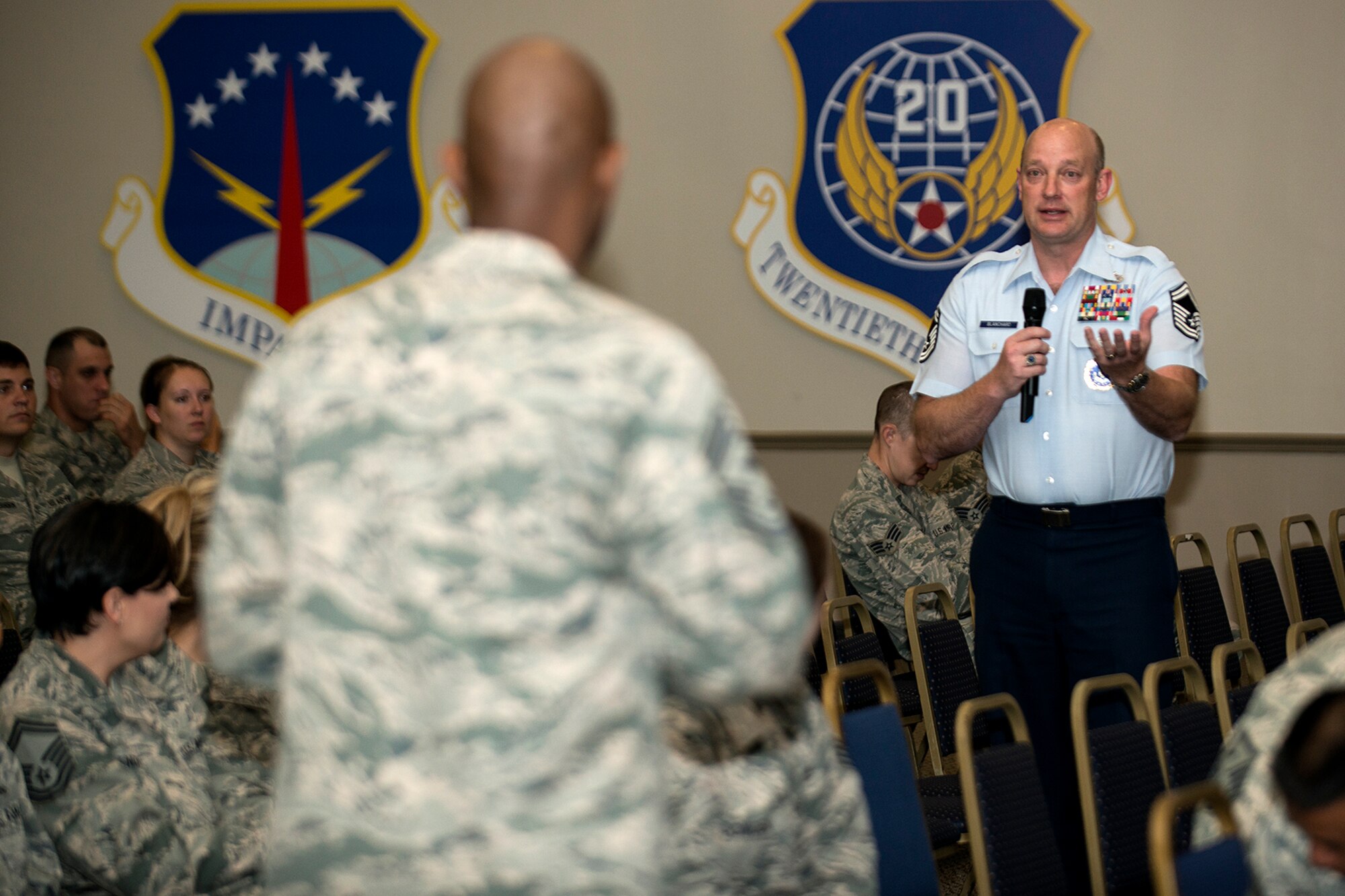 U.S. Air Force Senior Master Sgt. Roy Blanchard, 307th Bomb Wing (BW) recruiter, asks Air Force Reserve Command Chief Master Sgt. Cameron Kirksey a question during an Enlisted Call on June 8, 2014, Barksdale Air Force Base, La. The Enlisted Call included a questions and answers session to talk about the needs and concerns of Airmen assigned to the 307th BW. (U.S. Air Force photo by Master Sgt. Greg Steele/Released)