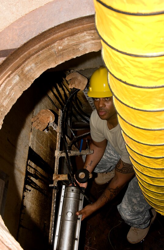 SSG Anthony Carson, 364TH Training Wing Squadron student, replaces an old faulty 25 pair telecommunication cable with new cable in an underground environment June 5, 2014. Students ensure safe environment by setting up all safety devices, testing underground environment for any unsafe conditions, Removing splice closure, splicing in new cable, removing old cable, testing new cable and reinstalling splice closure. (U.S. Air Force photo by Danny Webb/Released)