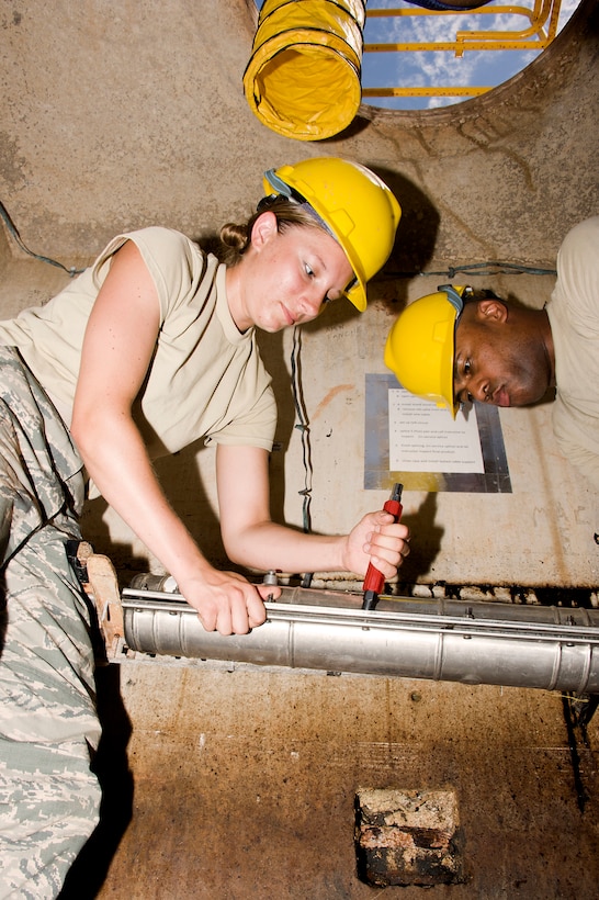 Airmen 1ST Class Samantha Skrypek and SSG Anthony Carson, students at the 364TH Training Wing Squadron replace an old faulty 25 pair telecommunication cable with new cable in an underground environment June 5, 2014. Students ensure safe environment by setting up all safety devices, testing underground environment for any unsafe conditions, removing splice closure, splicing in new cable, removing old cable, testing new cable and reinstalling splice closure. (U.S. Air Force photo by Danny Webb/Released)