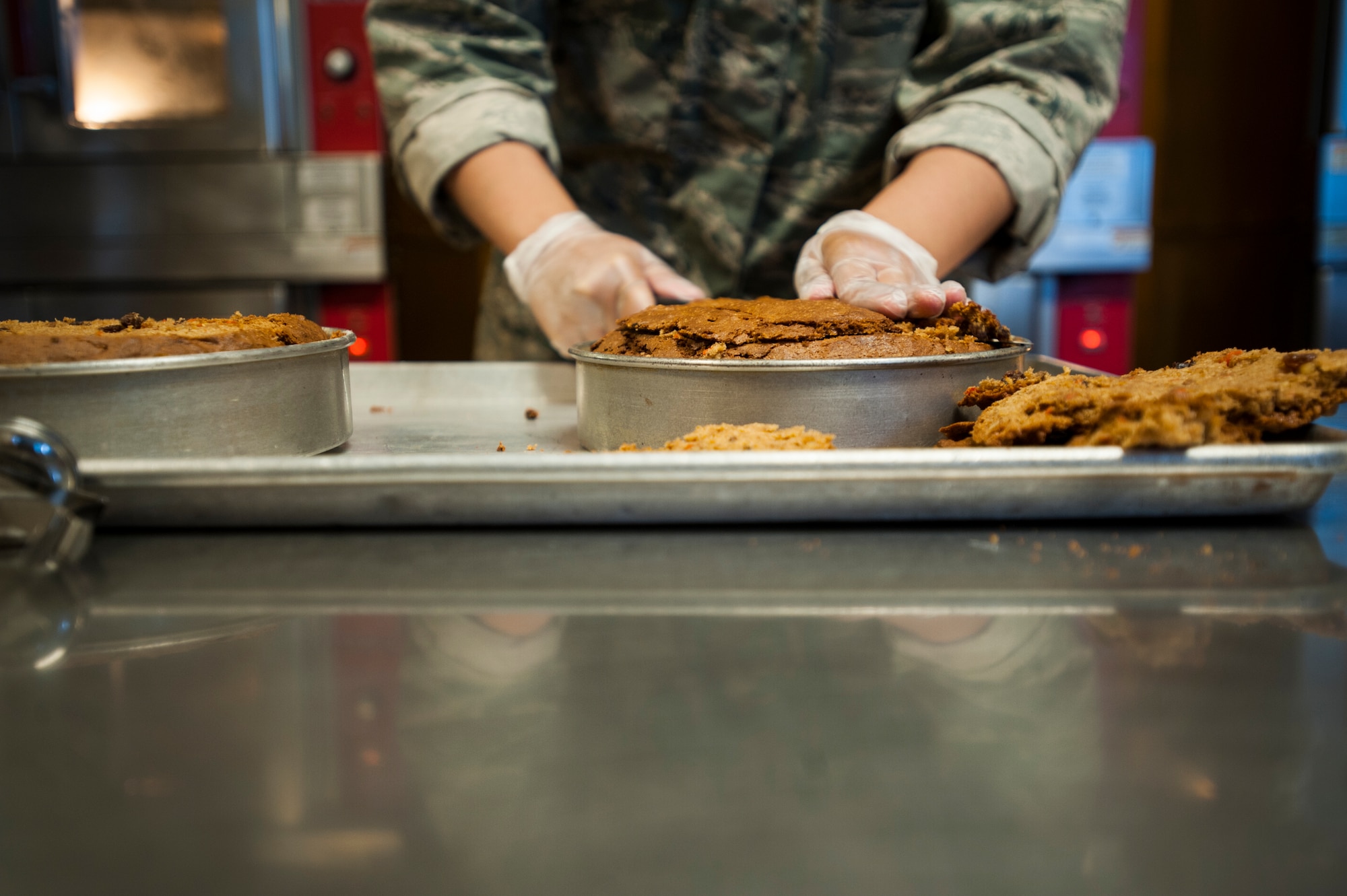 A chef from the 5th Force Support Squadron cuts a cake at the Dakota Inn dining facility at Minot Air Force Base, N.D., June 5, 2014. The dining facility staff is committed to providing Airmen with a wide variety of homemade meals and desserts. (U.S. Air Force photo/Airman 1st Class Apryl Hall)