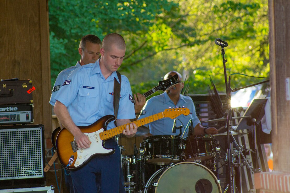 Senior Airman Andrew Thompson plays a guitar solo with Space A, our small rock band