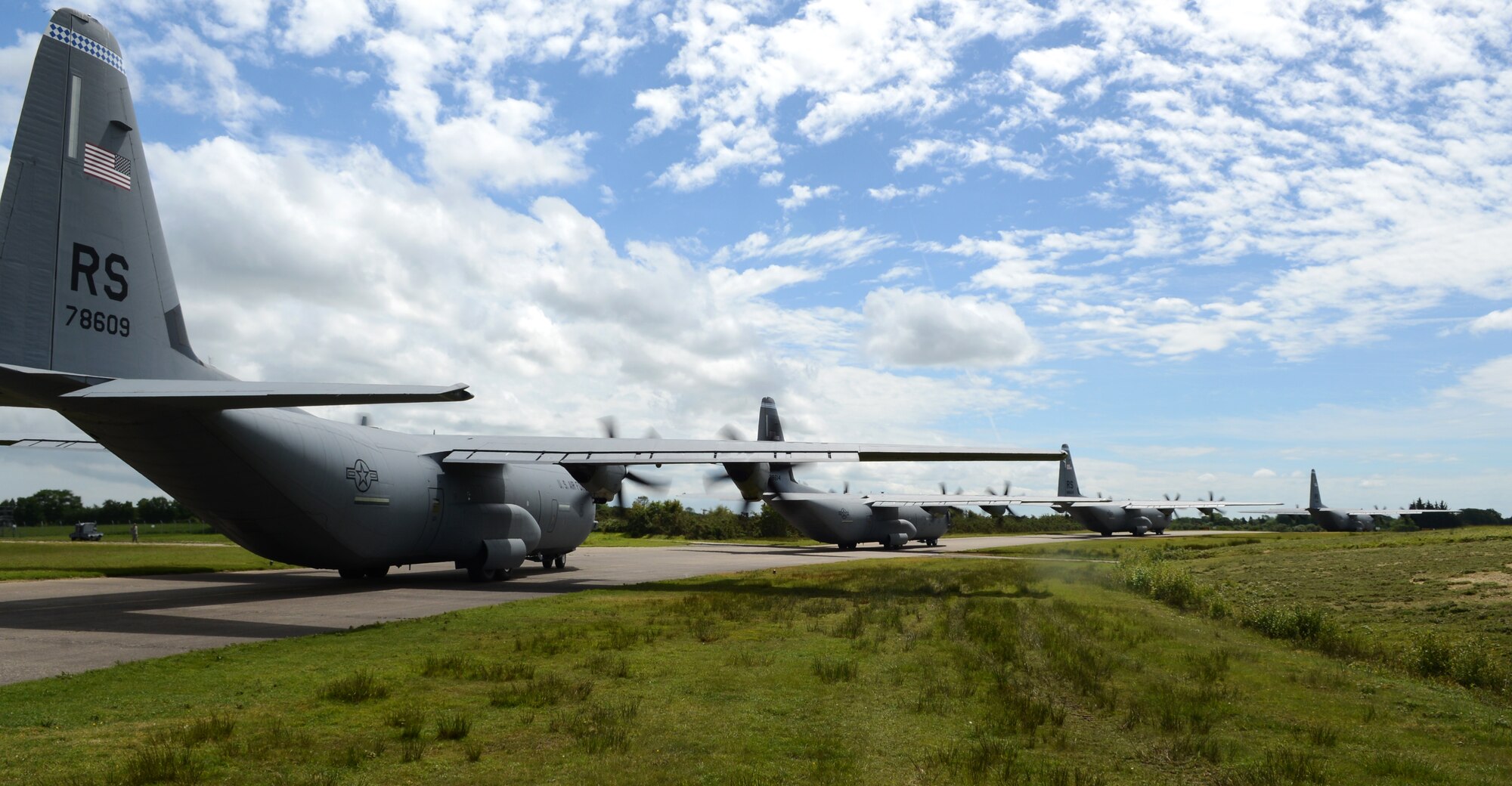 A four-ship of C-130J Super Hercules’ from Ramstein Air Base, Germany, taxi to the runway before a formation flight from Cherbourg Maupertus Airport, France June 7, 2014. The U.S. Air Force and other allied air forces performed flyovers throughout France in support of the 70th anniversary celebration of D-Day. (U.S. Air Force photo/Airman 1st Class Dillon Johnston/Released)