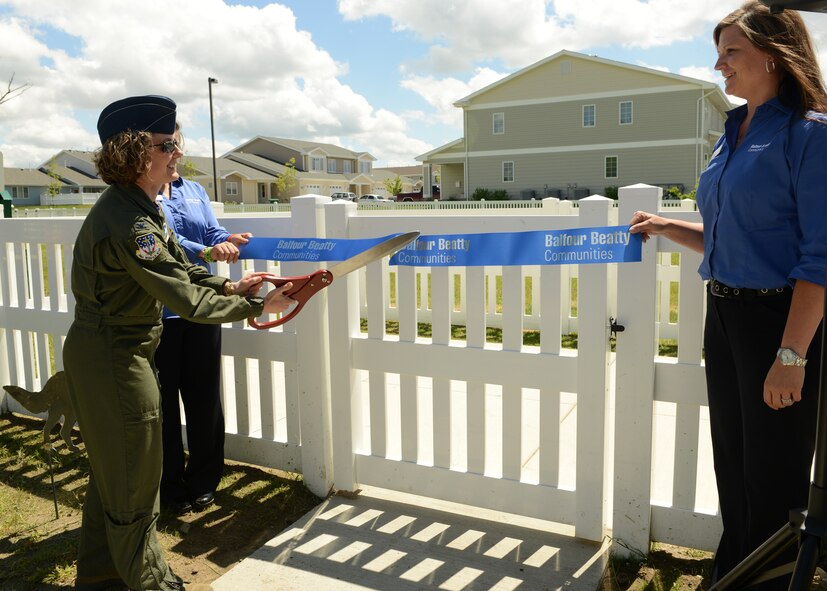 Col. Marné Deranger, 341st Missile Wing vice commander, cuts a ribbon during the grand opening of Malmstrom’s first dog park, sponsored by Balfour Beatty Communities. The dog park includes a large park and a separate park small dogs. (U.S. Air Force photo/Senior Airman Katrina Heikkinen)