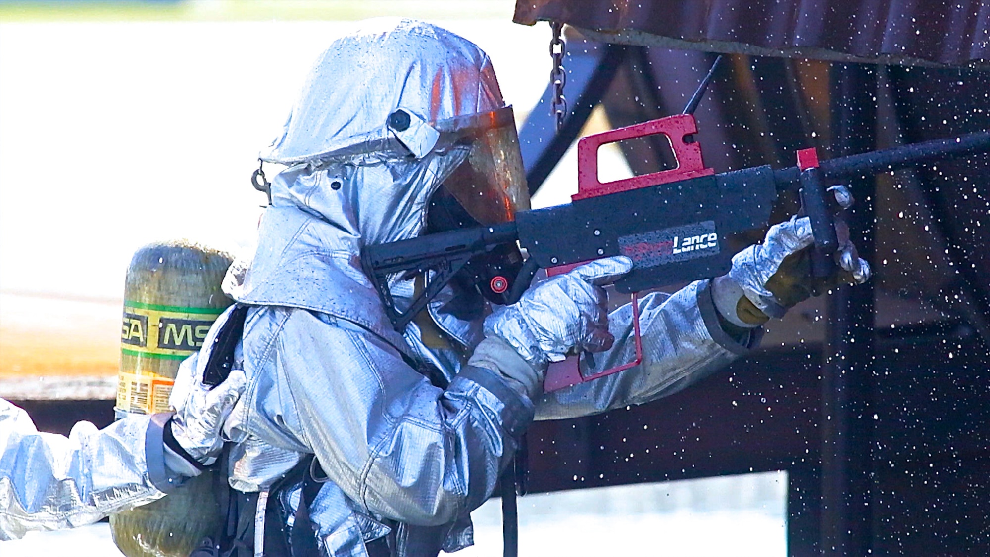 Senior Airman Frank Butler, firefighter with the 325th Civil Engineer Squadron at Tyndall Air Force Base, Fla., uses a PyroLance system during aircraft rescue firefighting training on Feb. 25, 2014. The PyroLance is a hand-held, ultra-high pressure piercing and firefighting tool designed to help firefighters safely fight hard-to-reach or hidden fires in structures, aircraft or in areas contaminated by hazardous materials. (U.S. Air Force photo/Eddie Green/Released)