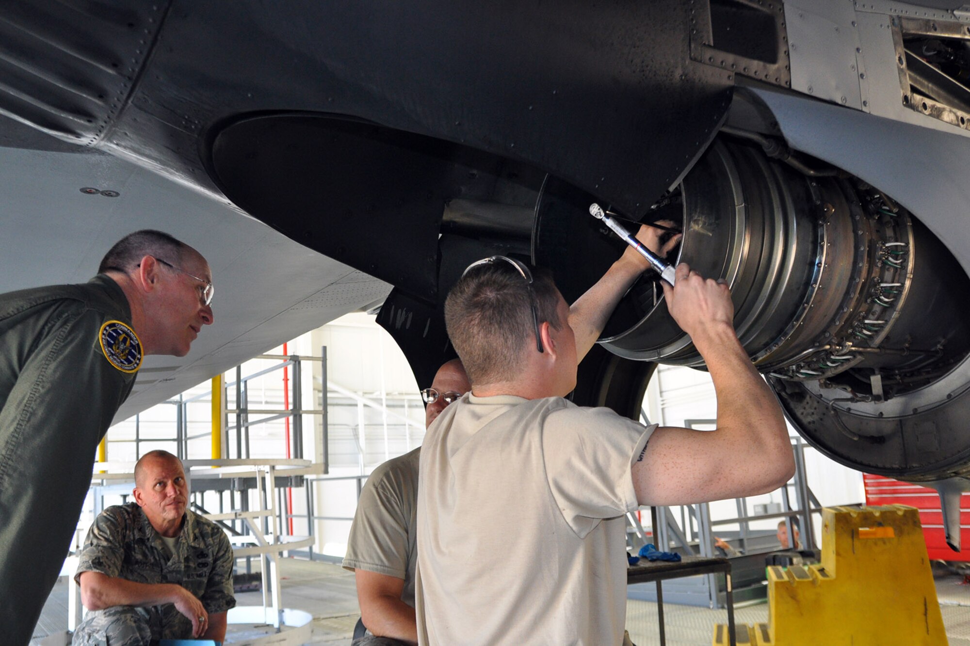 YOUNGSTOWN AIR RESERVE STATION, Ohio – Air Force Reserve Commander Lt. Gen. James J. Jackson watches as Air Force Reserve Airman Ryan Morahan, a 910th Maintenance Squadron propulsion systems apprentice, works on one of the turboprop engines of C-130 Hercules aircraft in the Isometric Inspection Dock (ISO) here, June 7, 2014. Col. David Post, 910th Maintenance Group commander and Master Sgt. Jim Delgros, a 910th Maintenance Squadron propulsion systems craftsman, also look on as Morahan works on the engine. General Jackson toured the ISO Dock as part of his visit to the installation to take a firsthand look at the 910th’s airlift capability, aerial spray mission and the air station’s facilities as well as future requirements. U.S. Air Force photo by Master Sgt. Bob Barko Jr.