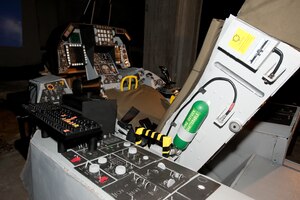 Made from recycled cardboard, bottle caps, an old entertainment center and other reclaimed materials, David Gatling has built a “green” F-16 simulator in the basement of his apartment complex in Newport News, Va. Gatling said the simulator is almost identical, except for materials, to a commercially-made one. (U.S. Air Force photo by Melissa Walther/Released)