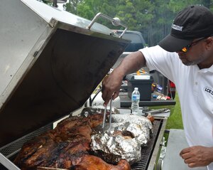 If it looks like a pig and smells really good ... EAT IT! Naval Support Activity held a BBQ and pig picking June 6, 2014, at Storm Pointe Conference Center on Joint Base Charleston - Weapons Station. One and half hogs and numerous pork butts were slow cooked and served up  with beans, cole slaw and macaroni and cheese during lunch to raise money for the upcoming Navy Ball. (U.S. Air Force photo/Eric Sesit)