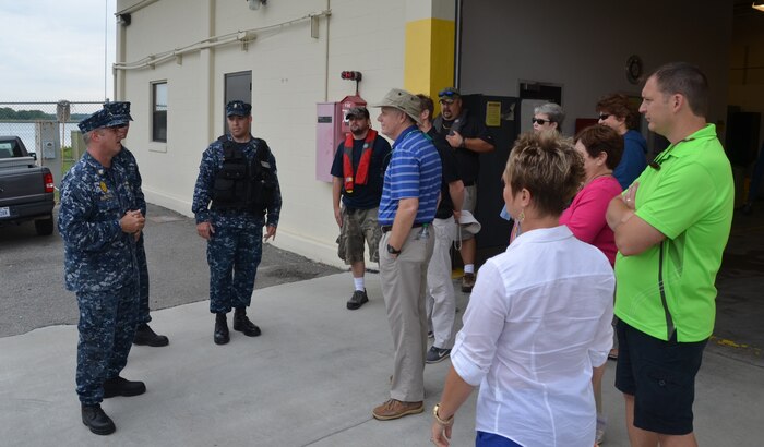 Lieutenant Commander Sean McMichael, 628th Security Forces Squadron Deputy Defense Force commander (left), welcomes Joint Base Charleston Honorary Commanders as they prepare to get underway onboard the 628th SFS patrol boats June 6, 2014, at JB Charleston – Weapons Station. The Honorary Commanders program was developed to encourage an exchange of ideas, experiences, and friendship between key members of the local civilian community and the Charleston military community.  The program provides a unique opportunity for members of the Charleston area to shadow commanders of groups, squadrons and tenant units at JB Charleston. (U.S. Air Force photo/Eric Sesit)