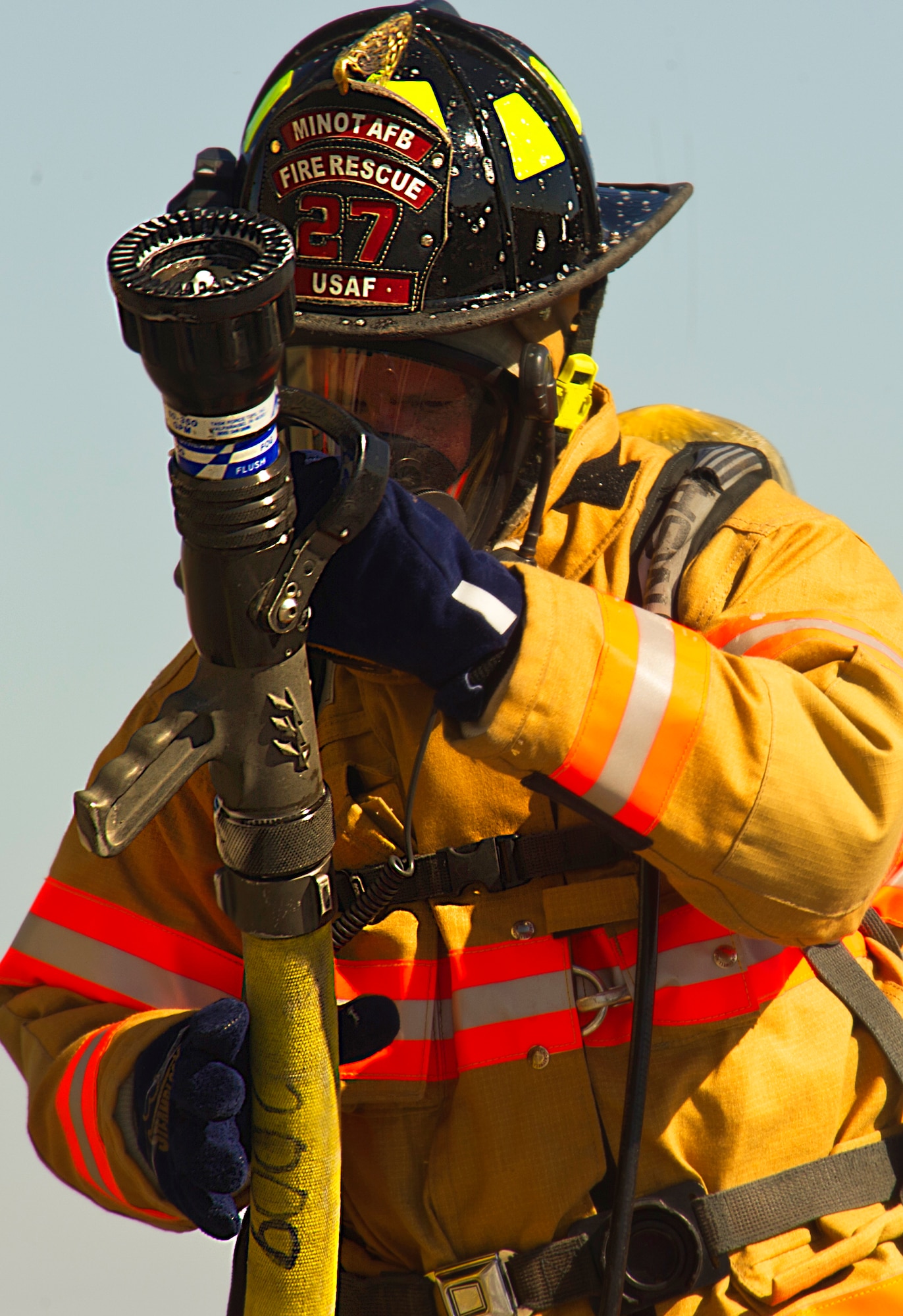 Firefighters from the 5th Civil Engineer Squadron check their equipment before participating in a controlled burn exercise at Minot Air Force Base, N.D., May 21, 2014. The fire training facility provides realistic training for the fire fighters with controlled flames emanating from specific areas of the building, and can be used in any type of weather to increase readiness of base and local community firefighters. (U.S. Air Force photo/Senior Airman Brittany Y. Bateman)