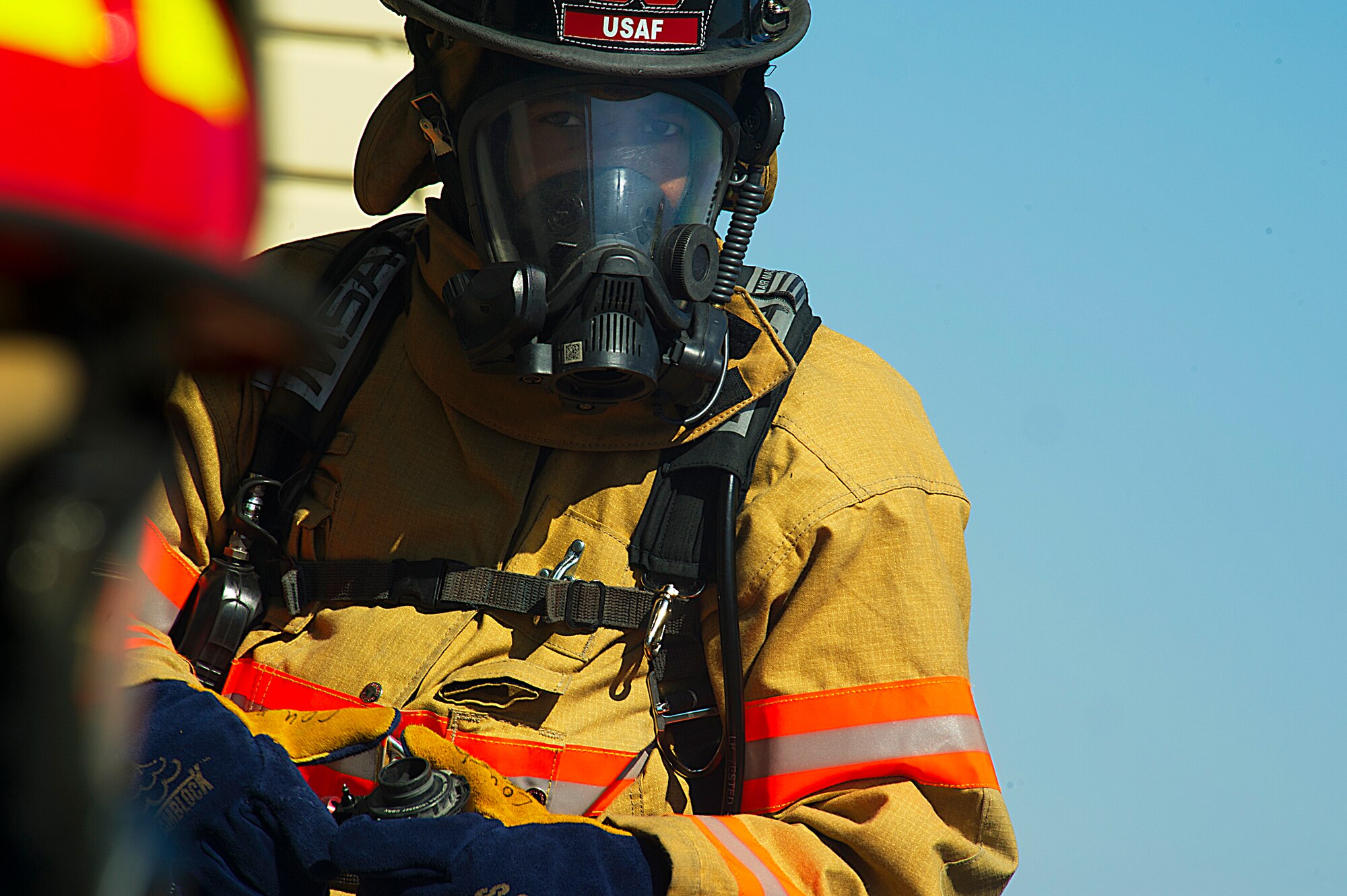 Firefighters from the 5th Civil Engineer Squadron check their equipment before participating in a controlled burn exercise at Minot Air Force Base, N.D., May 21, 2014. The fire training facility provides realistic training for the fire fighters with controlled flames emanating from specific areas of the building, and can be used in any type of weather to increase readiness of base and local community firefighters. (U.S. Air Force photo/Senior Airman Brittany Y. Bateman)