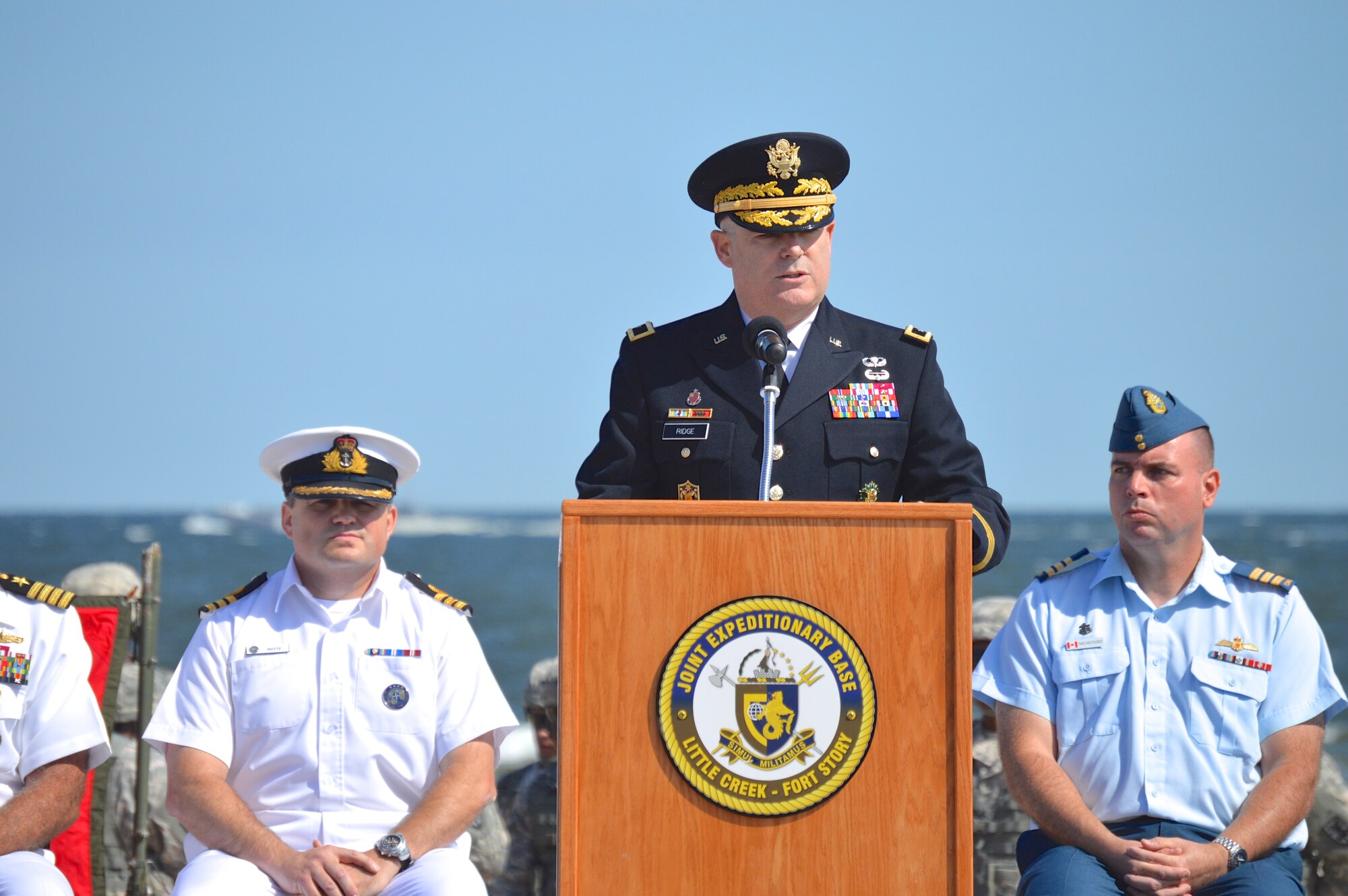 U.S. Army Maj. Gen. Ross E. Ridge, deputy commanding general of Army Initial Military Training, gives remarks during the 70th Anniversary D-Day Remembrance Ceremony at Joint Expeditionary Base Little Creek-Fort Story, Va., June 6,, 2014.  The ceremony also included an amphibious assault demonstration by the Navy, where Soldiers stormed the beach in reenactment. (U.S. Army photo by Spc. Marian Alleva/Released)