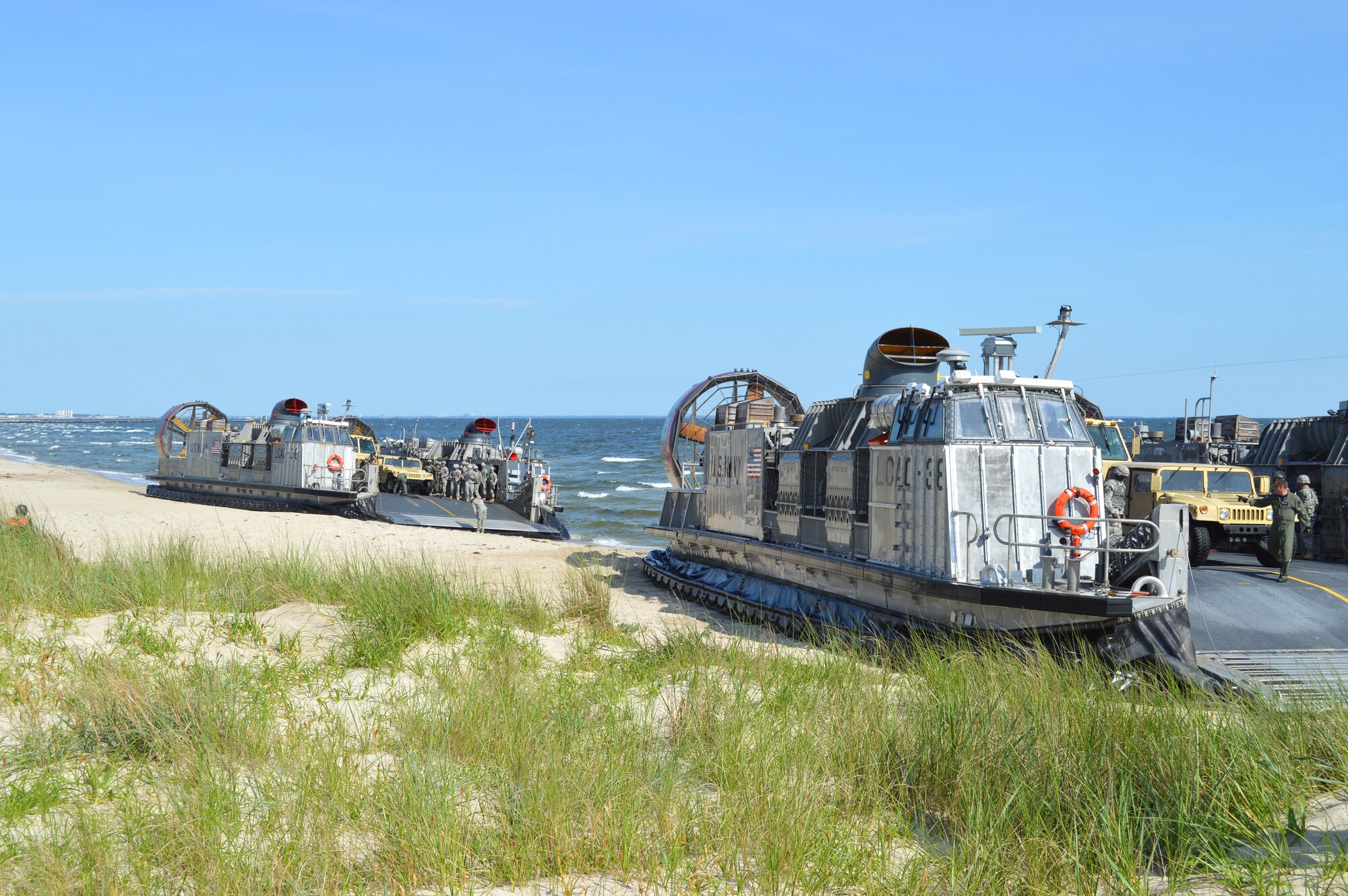 U.S. Navy amphibious watercrafts breach the shores of Enlisted Beach during the 70th Anniversary D-Day Remembrance Ceremony at Joint Expeditionary Base Little Creek-Fort Story, Va., June 6, 2014. Joint Expeditionary Base Little Creek-Fort Story was one of the bases used to help train Service members who went ashore on D-Day. (U.S. Army photo by Spc. Marian Alleva/Released)