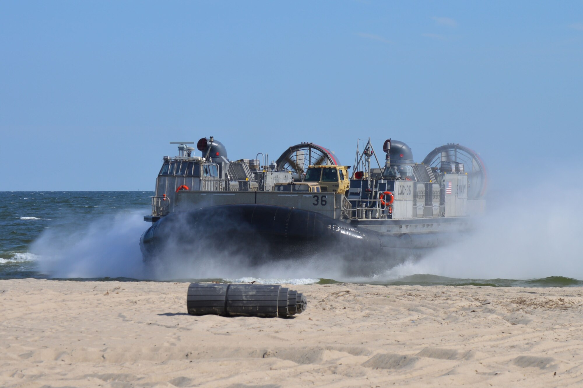 A U.S. Navy amphibious watercraft breaches the shores of Enlisted Beach during the 70th Anniversary D-Day Remembrance Ceremony at Joint Expeditionary Base Little Creek-Fort Story, Va., June 6, 2014. The installation was one of the bases used to help train Service members who went ashore on D-Day. (U.S. Army photo by Spc. Marian Alleva/Released)