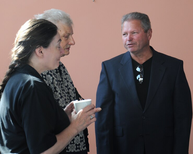 Team Mildenhall members speak with Mark Howell, right, 100th Air Refueling Wing historian from Odessa, Texas, during Heritage Day June 6, 2014, on RAF Mildenhall, England. The 100th ARW has close ties to the 100th Bombardment Group. (U.S. Air Force photo/Gina Randall/Released)