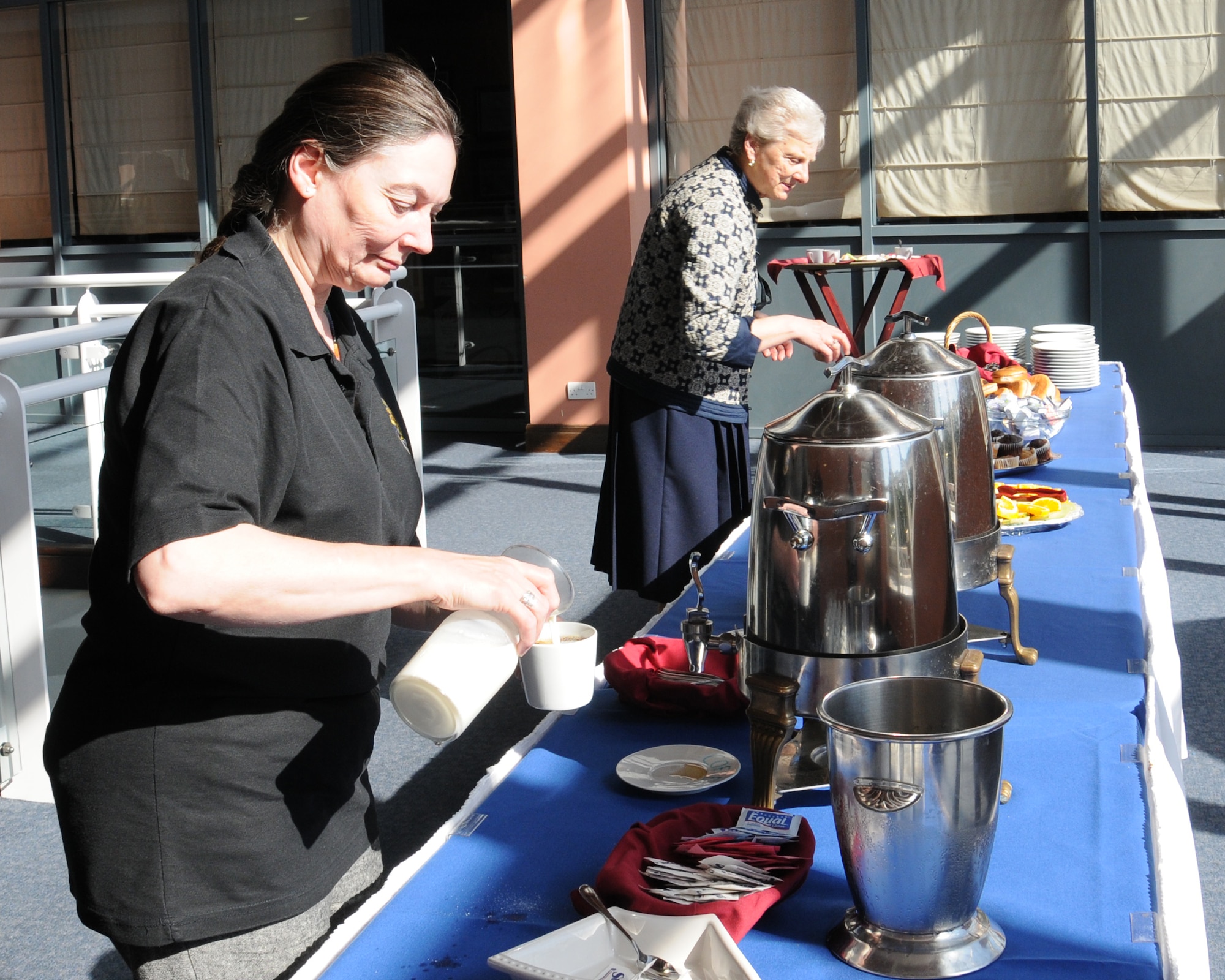 Team Mildenhall members participate in a breakfast to start Heritage Day June 6, 2014, on RAF Mildenhall, England. The 100th Air Refueling Wing has close ties to the 100th Bombardment Group. (U.S. Air Force photo/Gina Randall/Released)