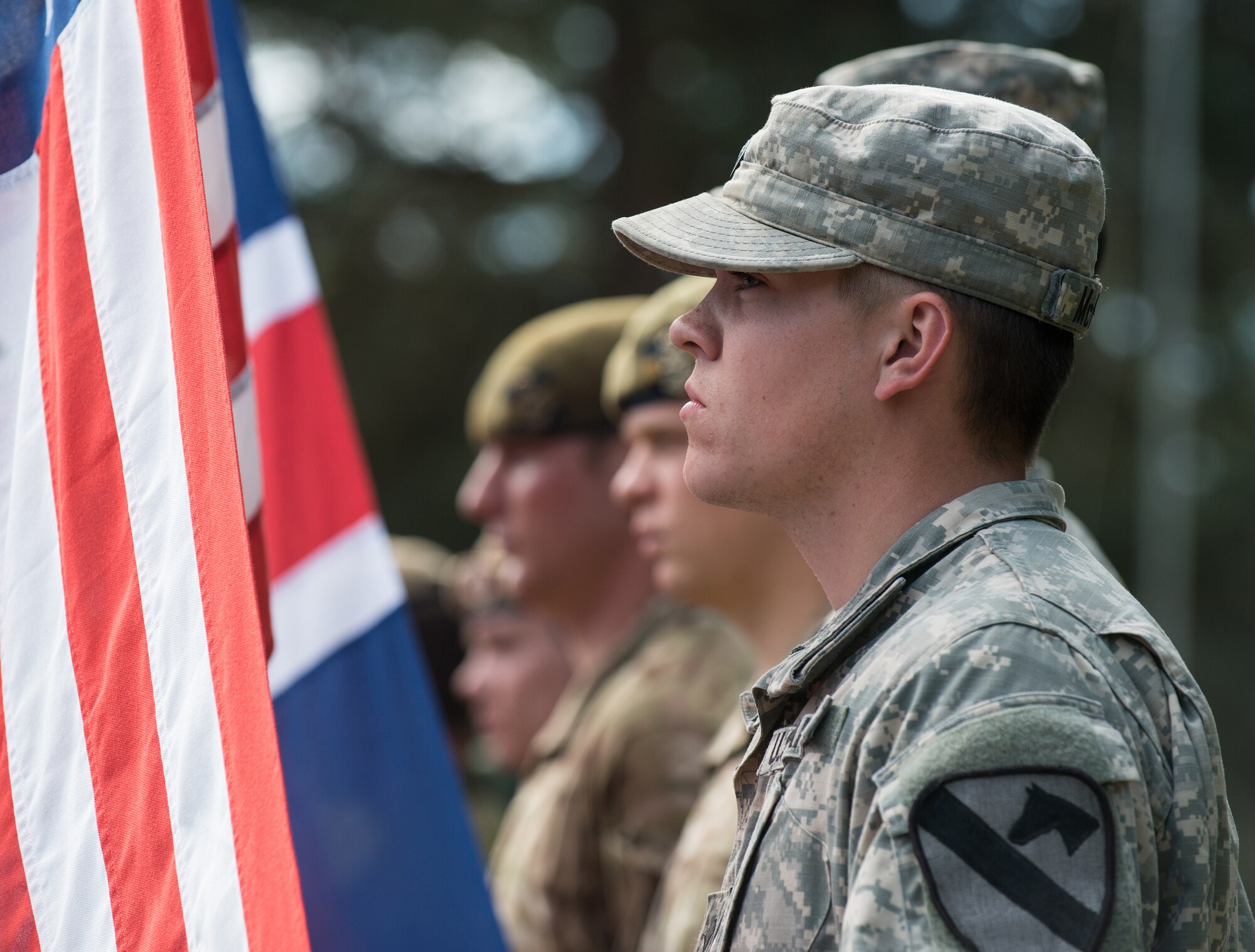 A U.S. Air Force Soldier stands ready to raise the American flag along with allied nations during the Saber Strike kick-off ceremony at the Adazi training area, Latvia, June 9, 2014. Saber Strike focused on command and control as well as interoperability with regional partners and will be comprised of host nation-supported command post, computer assisted, and situational training exercises. The U.S. Air Force will also be playing a role by providing close air support with partner nation ground forces and demonstrate air deployment of forces and equipment. (U.S. Air Force photo/Senior Airman Jonathan Stefanko)