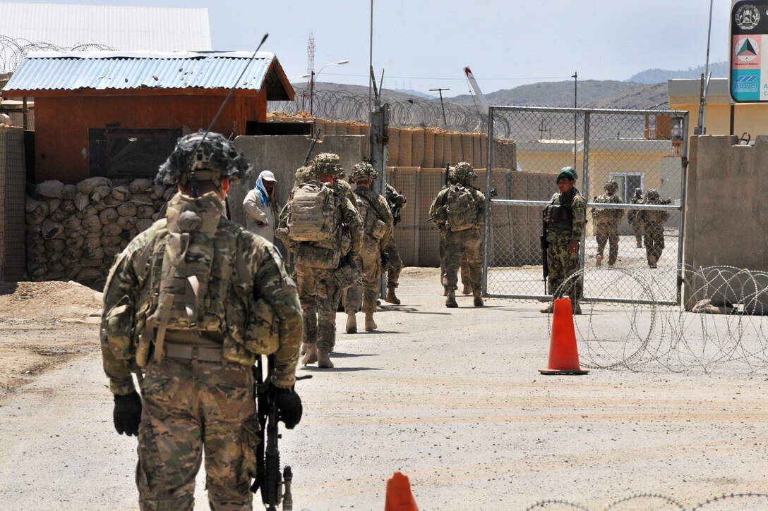 U.S. soldiers pass through the entrance control point on Forward Operating Base Thunder after conducting a patrol in Paktia province, Afghanistan, May 29, 2014.