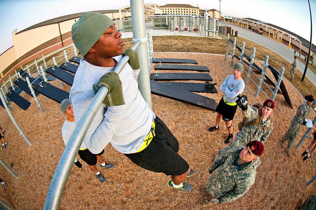 Army Staff Sgt. Iban Alverez completes as many chin-ups as he can in one minute during the Bandit Blitz team competition on Fort Bragg, N.C., Dec. 1, 2011. Alverez is a paratrooper assigned to the 82nd Airborne Division's 1st Brigade Combat Team. The competition focuses on individual soldier skills graded collectively in teams of four. The first block of the competition includes pushups, chin-ups and a three-mile run.  
