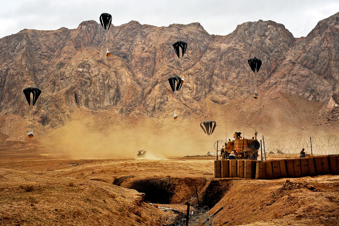 Aircrews drop supplies over a village stability platform in Shah Joy, Afghanistan, Nov. 26, 2011. The supplies sustain forward operating bases, combat outposts and service members living at those locations.  
