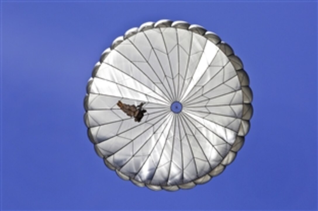 A parachute opens as a soldier conducts a training jump at the National Training Center on Fort Irwin, Calif., June 3, 2014. The training fulfills a requirement to maintain jump status, and remain proficient and ready for future contingencies.