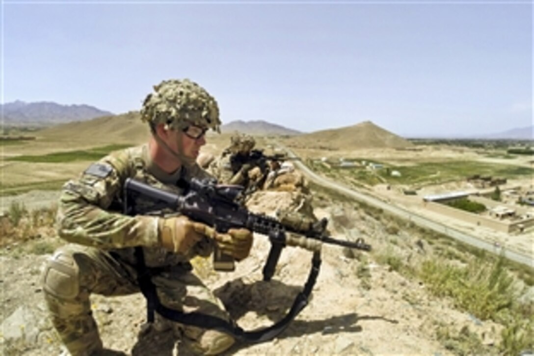 U.S. Army Sgt. Dempsey, foreground, and U.S. Army Pfc. Jones provide security above a road during a patrol in Paktia province, Afghanistan, May 29, 2014. Dempsey and Jones are assigned to the 10th Mountain Division's 3rd Squadron, 71st Cavalry Regiment, 3rd Brigade Combat Team.  