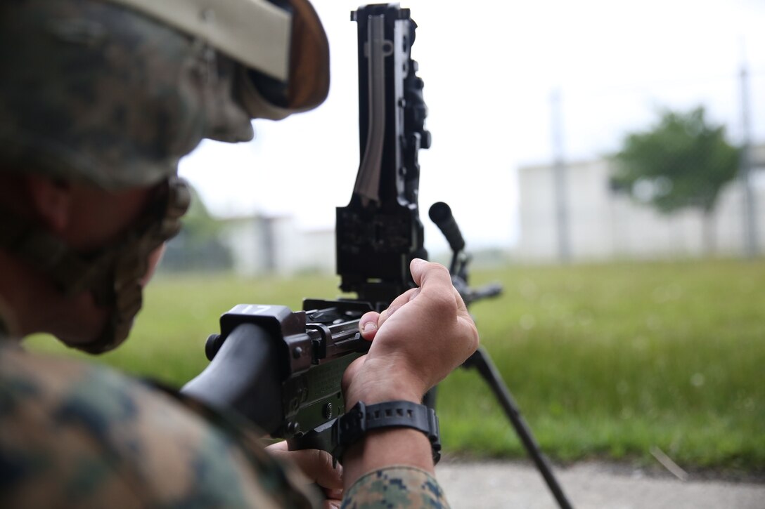 Lance Cpl. Adam Degraw executes a disassembly and reassembly drill with an M249 squad automatic weapon June 8 at Combined Arms Training Center Camp Fuji. During the Fuji Warrior training exercise, Marines and sailors with a non-infantry background familiarize themselves with weapons systems and combat tactics necessary to function within a provisional rifle platoon. Degraw is a field radio operator from Iuka, Miss., assigned to Combat Logistics Regiment 37, 3rd Marine Logistics Group, III Marine Expeditionary Force. (U.S. Marine Corps photo by Lance Cpl. Wes J. Lucko/Released)
