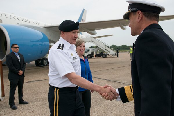 U.S. Army Gen. Martin E. Dempsey, chairman of the Joint Chiefs of Staff, and his wife, Deanie, exchange greetings with British Navy Rear Adm. Mackay as they arrive on Stansted Airfield, England, June 9, 2014. Dempsey later met with British Prime Minister David Cameron at his residence at No. 10 Downing Street and with defense counterparts at the British Defense Ministry.