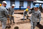 Air Force Staff Sgt. Joshua Denniston steps out of a trench that will eventually become the foundation of a women's clinic in the Guatemalan town of Tactic. Denniston, an Airman with the Arkansas Air National Guard's 188th Civil Engineering Squadron, is deployed to Guatemala in support of Beyond the Horizon 2012 and will spend two weeks working in Tactic to nearly double the available space of the Centro de Salud clinic. (U.S. Army photo by Spc. Anthony D. Jones)