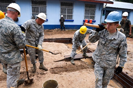 Air Force Staff Sgt. Joshua Denniston steps out of a trench that will eventually become the foundation of a women's clinic in the Guatemalan town of Tactic. Denniston, an Airman with the Arkansas Air National Guard's 188th Civil Engineering Squadron, is deployed to Guatemala in support of Beyond the Horizon 2012 and will spend two weeks working in Tactic to nearly double the available space of the Centro de Salud clinic. (U.S. Army photo by Spc. Anthony D. Jones)