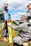 Army Sgt. First Class Robert Ferderer, left, Army Staff Sgt. Chris Keller, center, and Army Staff Sgt. Jason Horner, all members of the North Dakota National Guard's 81st Civil Support Team, assemble a device belonging to the Department of Energy that allows them to measure the amount of radiation in the air. The 81st CST, based in Bismarck, N.D., participated in a three-day Nuclear Weapons Accident/Incident Exercise at Minot Air Force Base, N.D., involving nearly 400 people from multiple federal and state agencies.