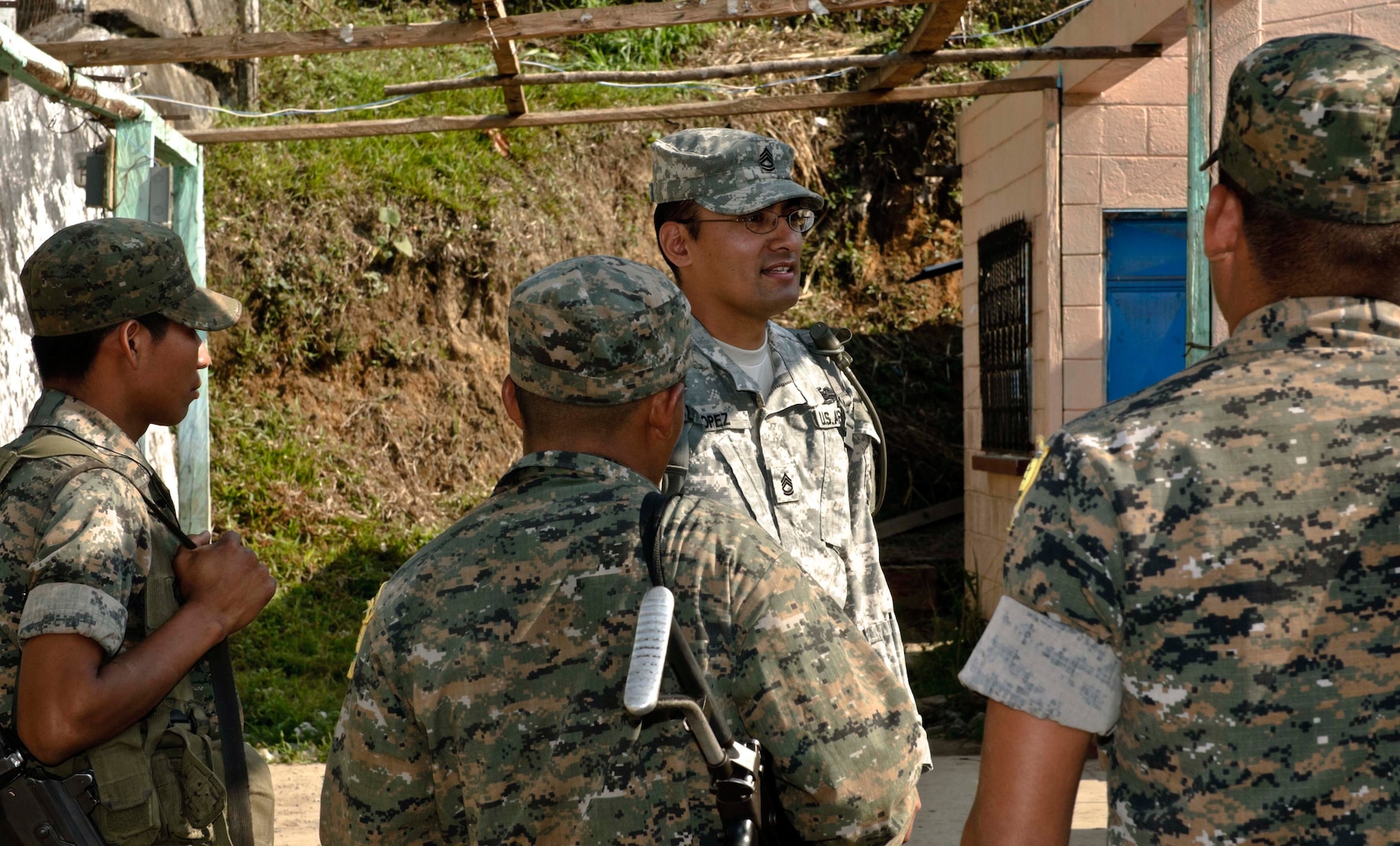 Sgt. 1st Class Angel Lopez, with the Utah Army National Guard's 300th Military Intelligence Brigade, discusses the upcoming day with Guatemalan security forces while taking part in Beyond the Horizons 2012. Sgt. Lopez volunteered to go to Guatemala and utilizes his linguistic skills to communicate and coordinate with Guatemalan military and civilian personnel.