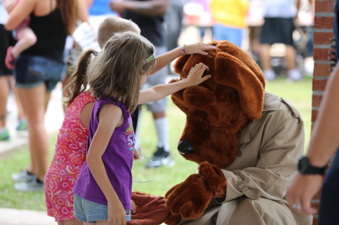 Children of Marines and Sailors pet “McGruff,” the crime-fighting dog during Marine Wing Support Squadron 274’s family day at Marine Corps Air Station Cherry Point, N.C., June 6, 2014. During the event representatives from on-base organizations like Marine Corps Family Team Building, the Provost Marshals Office and the USO came to share with families the many resources offered on base for both spouses and active duty Marines and Sailors. 