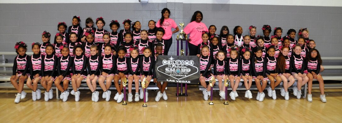 Members of the Barstow Superstars cheerleading team celebrate with their trophy after winning regionals, March 23. The team, coached by Britney Gray, supply technician on Marine Corps Logistics Base Barstow, Calif., went on to win nationals for their division. 