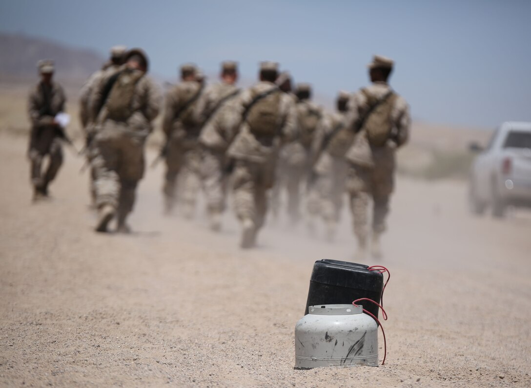 Combat Logistics Battalion 451, 2nd platoon, Marines walk away from what has been deemed an improvised explosive device and ready to set up a cordon area around the simulated explosive in a motorized operational training exercise at Marine Corps Air Ground Combat Center Twentynine Palms, CA during Integrated Training Exercise 4-14 on June 8, 2014.  ITX 4-14, a cornerstone of the Marine Air Ground Task Force Training Program, is the largest annual U.S. Marine Corps Reserve training exercise; helping establish best practices, refine planning guidance and baseline requirements for future Reserve units. ITX employs assets from ground, air and logistics combat elements to demonstrate the ability to deploy rapidly and build up significant combat power necessary to form a MAGTF.